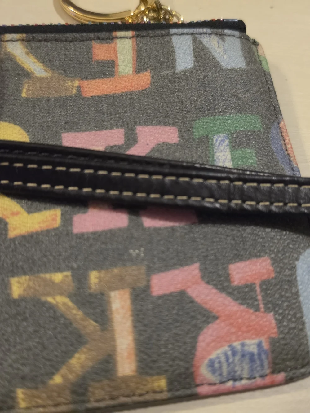 Dooney & Bourke Vintage multicolor letter/graffiti print coated Wristlet